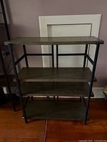 Front view of 4-shelf wood and metal shelving unit