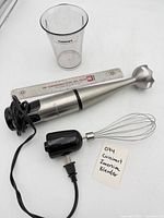 Immersion blender handle with blending shaft, whisk attachment, measuring cup
