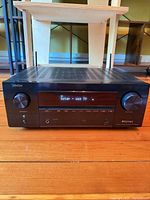 Front view of Denon AVR-X3800H receiver powered on