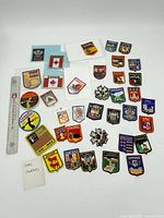 Full group of approximately 35 embroidered patches with ruler for scale