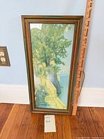 Full view of framed print with ruler for scale