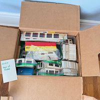 Open cardboard box showing numerous slide stacks, zip bags and slide boxes