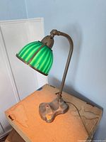 Full view of lamp showing shade, arm and base