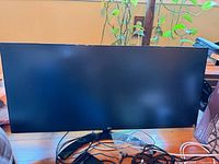 Front view of LG ultrawide monitor with accessories on desk