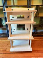 Front view showing four shelves and cable holes