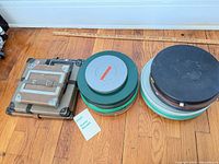 Stacked metal film cans and cardboard cases on floor