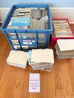Crate and stacks of postcards sorted by state