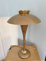 Full view of lamp showing saucer shade, stem, base