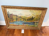 Full view of painting in frame against wall