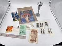 Group shot of all Seattle World’s Fair ephemera, ruler, metal Space Needle model