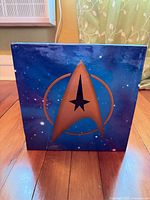 Front of slipcase with Starfleet delta design