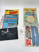 Overall lot showing all magazines, manual, cut-out book and bagged sheets