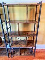 Front view of full bookcase showing five shelves and dividers