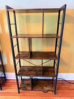 Front view of bookcase showing five shelves and metal frame