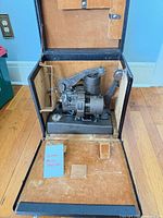 Projector mounted inside open carrying case