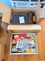 Overall lot showing two boxes containing viewer, wood case, cardboard boxes and accessories