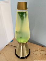 Full view of lava lamp showing base, cap, cord and fluid
