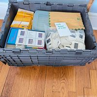 Bin containing boxes of Kodak slides, loose slides in bag and envelope