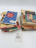 Two stacks of vintage cookbook pamphlets