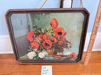 Full view of framed floral print with ruler for scale
