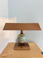 Full view of lamp unlit showing base, globe, shade