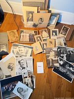 Overview of tub and spread of vintage photographs on floor