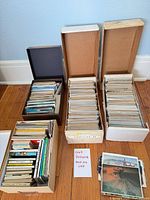Five boxes filled with upright postcards plus loose examples and note card