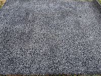 Full view of grey shag area rug laid flat outdoors