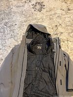 Grey Calvin Klein jacket with black removable liner displayed