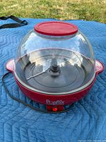 Popcorn maker full view showing dome lid, base, cord