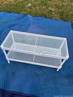 overall view of white metal two-tier shoe rack