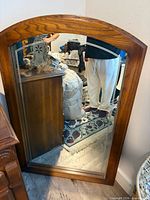 Front view of arch-top oak framed mirror