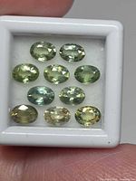 Ten oval sapphires in white gem box, top view