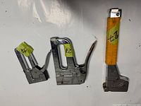 Side view of Arrow T50 and Stanley TR45 staplers with labels visible.