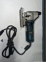 Left side view of Bosch 1584AVS jigsaw showing power cord and housing