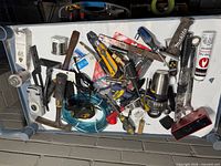 Overview of tray showing assorted tools and hardware