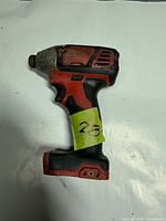 Left side view of the Milwaukee M18 impact driver body showing wear and missing battery