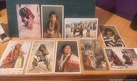 Nine Indigenous American portrait postcards laid out on tabletop