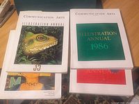 Four Communication Arts annual magazines stacked showing covers
