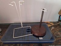 Two doll stands on top of blue velvet jewelry tray
