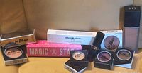 Full lot showing all boxed cosmetics on seat