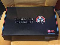 Closed black Lipfi's Barbershop box showing brand logo and coloured accents