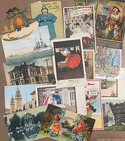 Full spread of assorted vintage postcards showing variety of themes and colours