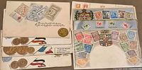 Stack of eight postcards showing stamp designs and crest motifs