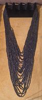 Full view of necklace on display form showing length and multi-strand construction