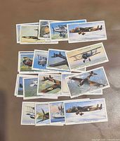 All 20 Player's Cigarettes aircraft series cigarette cards spread on surface