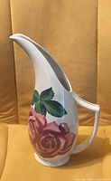 Right side view showing floral design and long spout