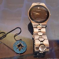 Front view of Fossil stainless steel watch and turquoise crystal star bracelet