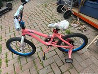 Left side view of entire pink Dynacraft Monster High 18" bike with training wheels