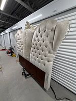 Full view of upholstered wingback headboard with footboard panel and metal rails